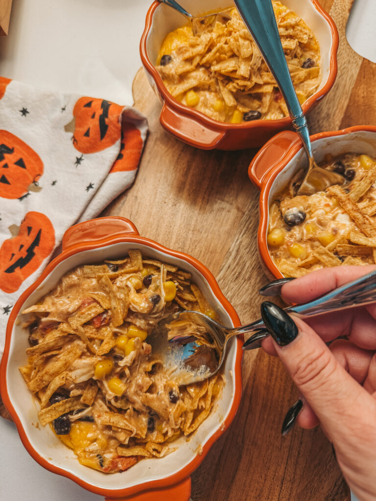 bowl of crockpot chicken enchilada casserole topped with cilantro and tortilla strips