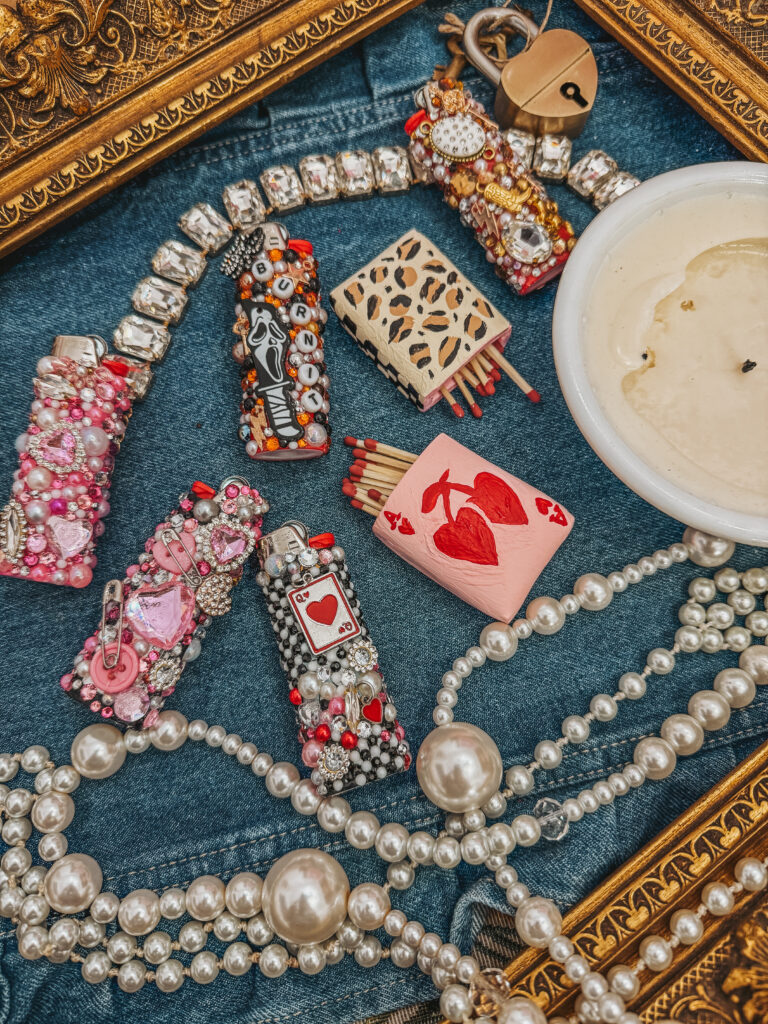 Hand decorated clay matchbox covers with beads,pearls, and vintage inspired embellishments displayed on a decorative tray