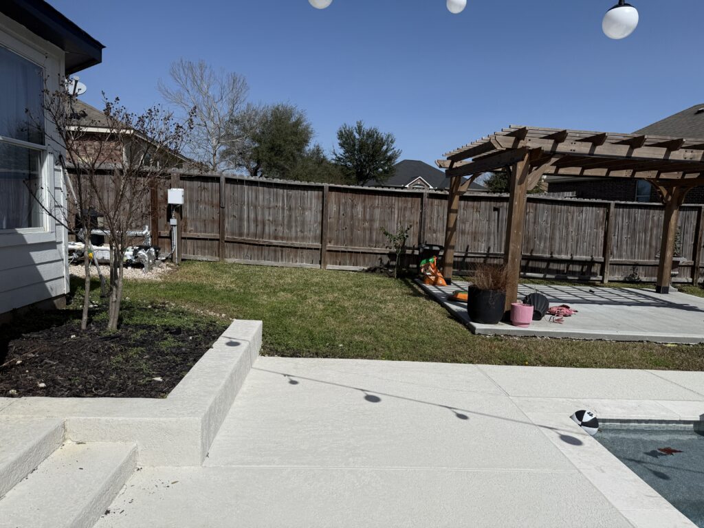 plain grass yard with a basic wooden pergola and a weathered swing set.