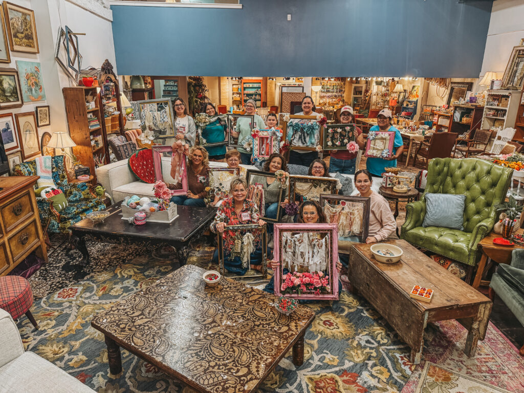 Women smiling and crafting together at the Petals and Patina shabby chic DIY event hosted at Granny Camp.