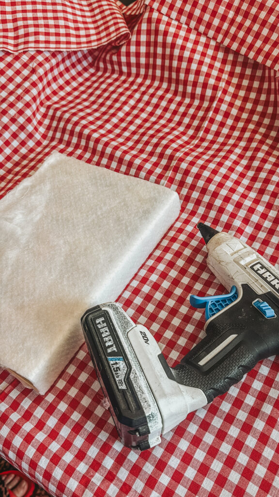 Crafting materials laid out for a DIY recipe junk journal project, including blue denim, leopard print fabric, and a vintage 'Duncan Hines Bake Shop in a Book' cookbook.