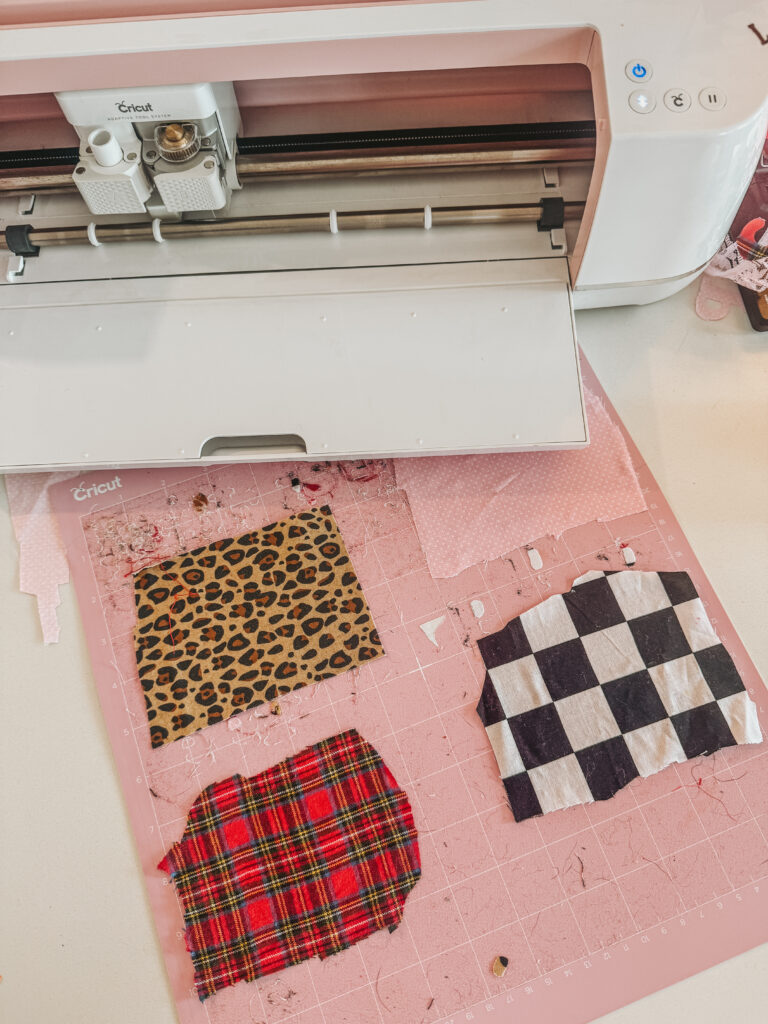 showing steps to make a DIY recipe journal.  a Cricut machine cutting patterned fabric on a pink mat. 