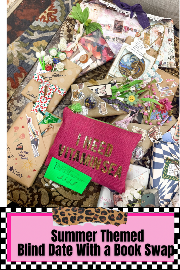 A close-up of beautifully decorated, summer-themed wrapped books adorned with stickers, faux flowers, and ribbons, centered around a hot pink "I NEED VITAMIN SEA" zippered makeup pouch.